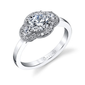 Classic three stone diamond engagement ring with a milgrain accented halo